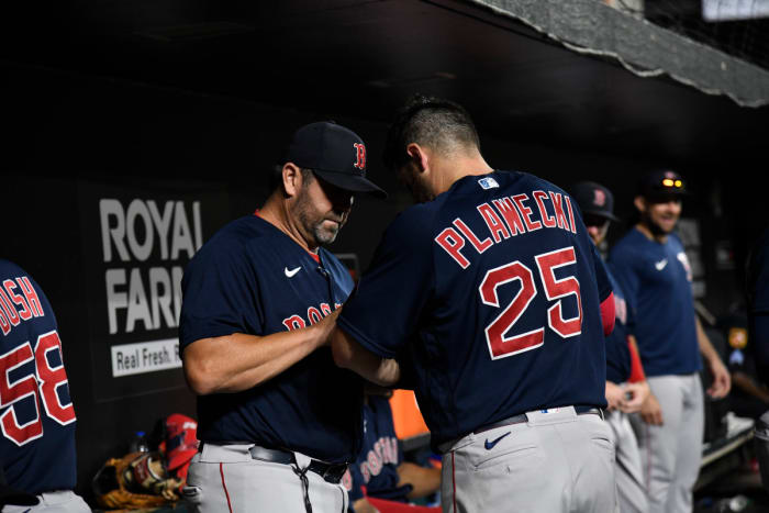 Boston Red Sox game planning coordinator/catching coach Jason Varitek (33) works with catcher Kevin Plawecki (25) in the dugout during the seventh inning against the Baltimore Orioles at Oriole Park at Camden Yards. (2022)